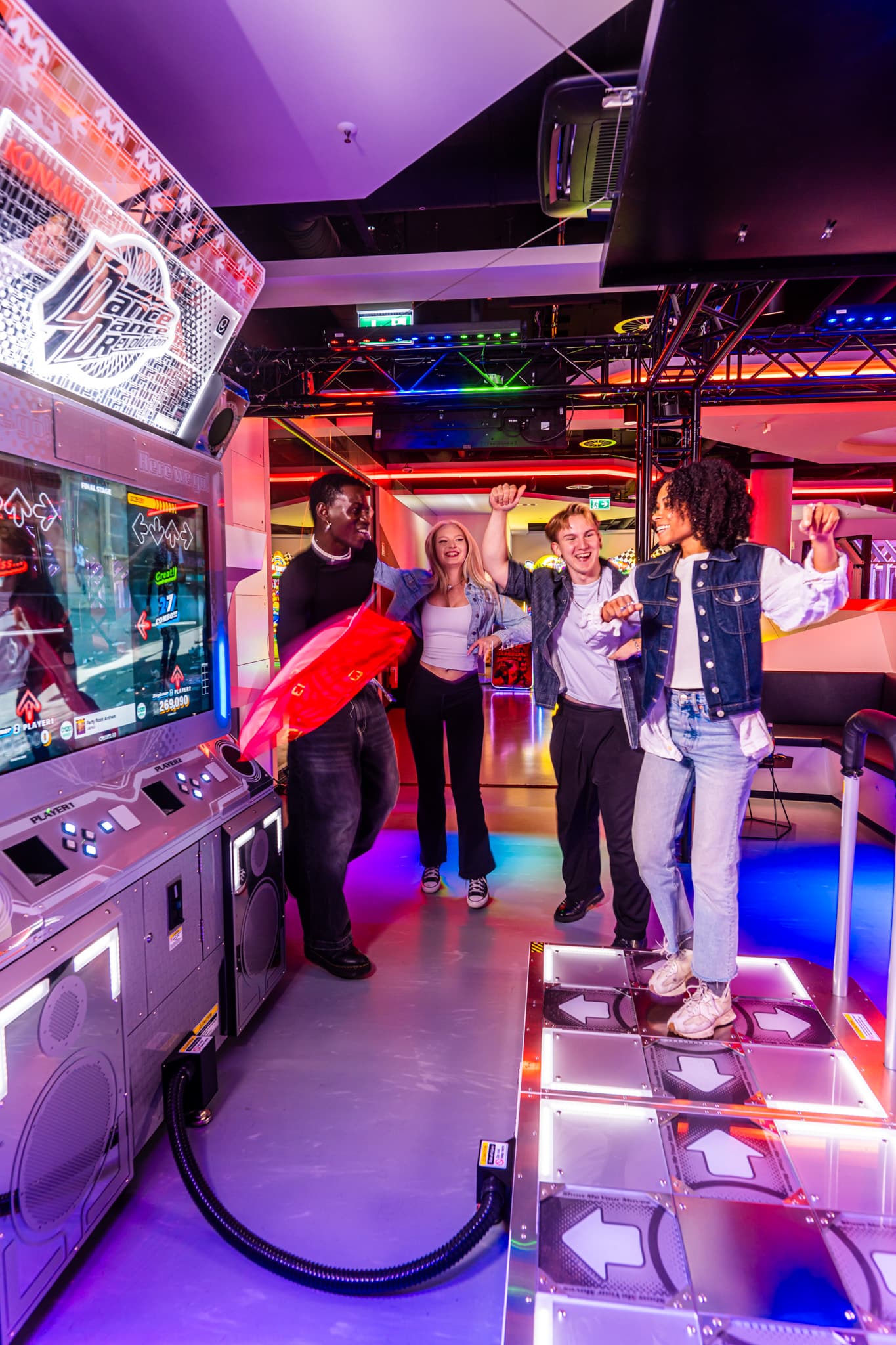 Friends dancing together on the DDR World cabinet at LVL