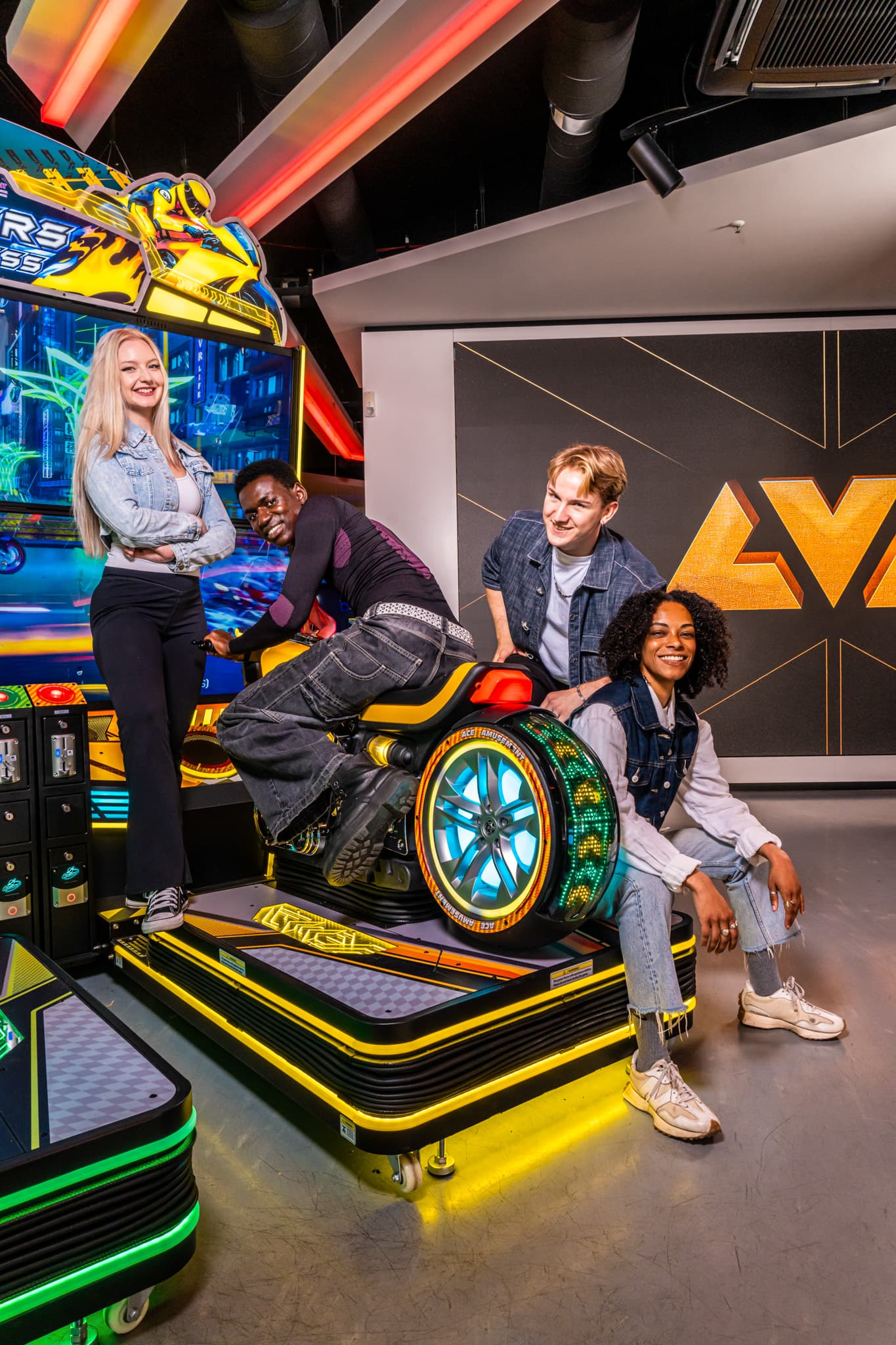Friends posing together on the racing bike cabinet at LVL