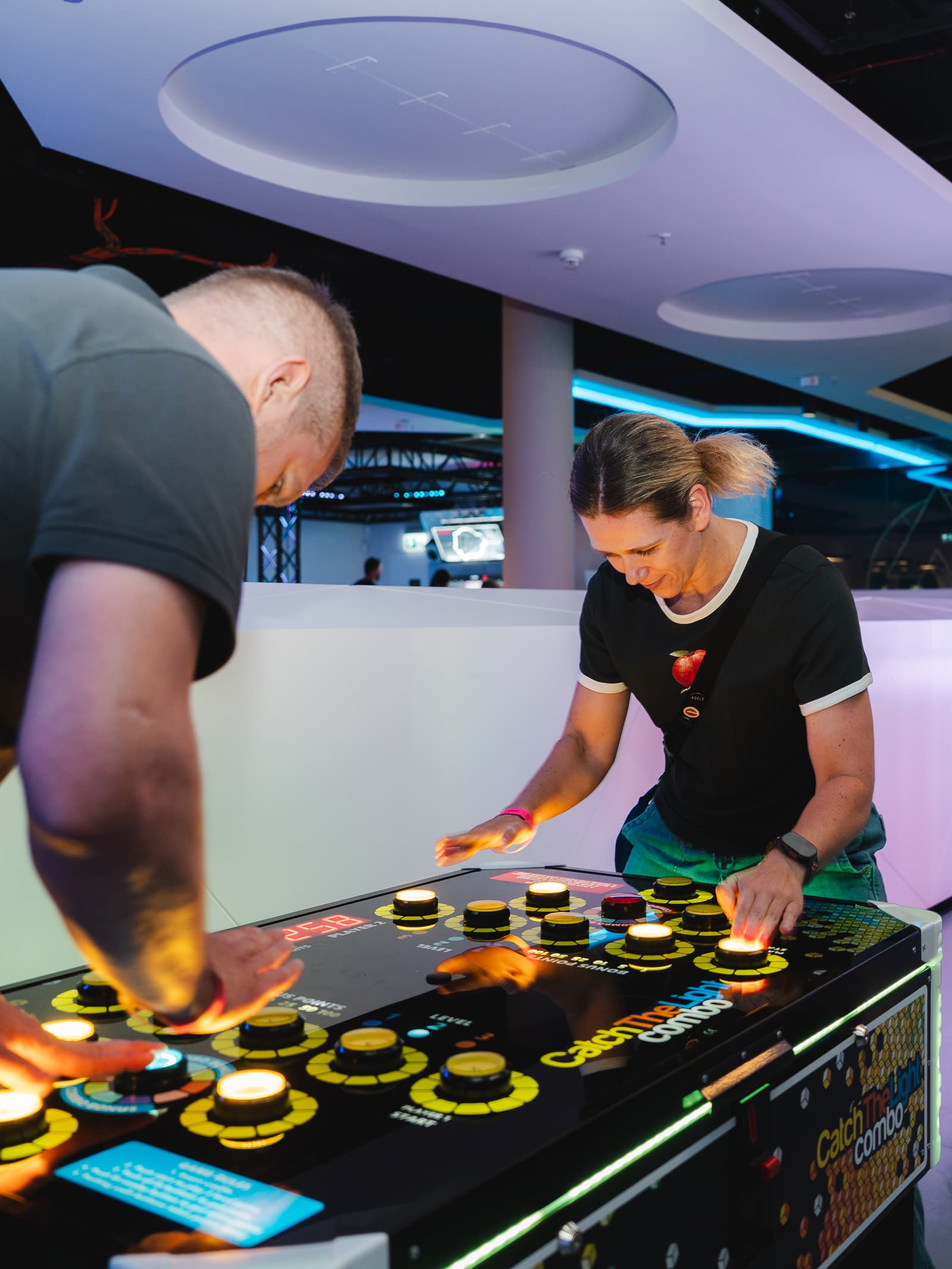Guests playing a light-up arcade game at LVL