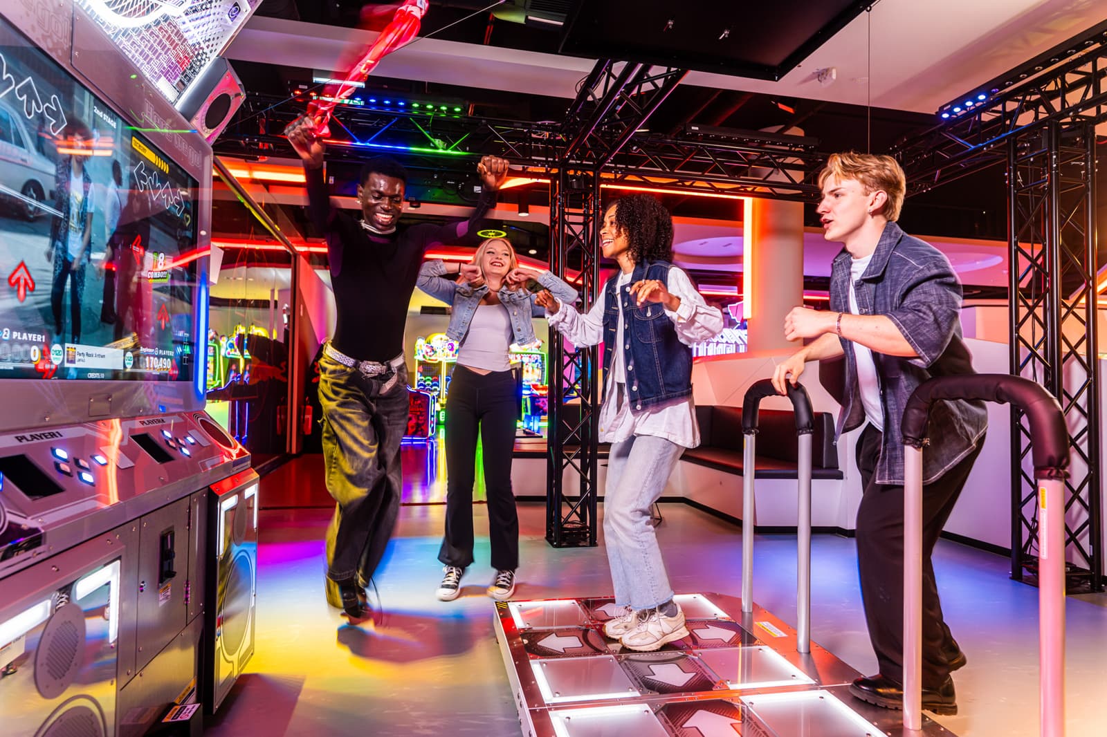 A group of friends jumping and dancing together on the DDR World dance floor at LVL Berlin