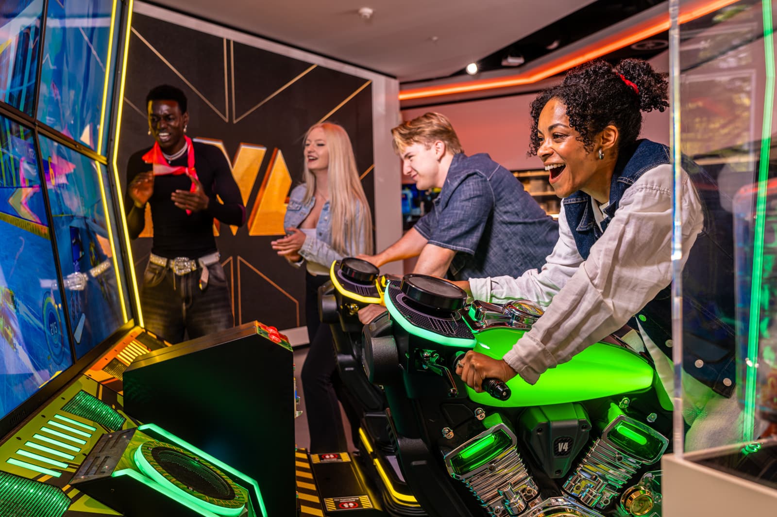 Team laughing together at an arcade racing cabinet during a corporate event at LVL Berlin