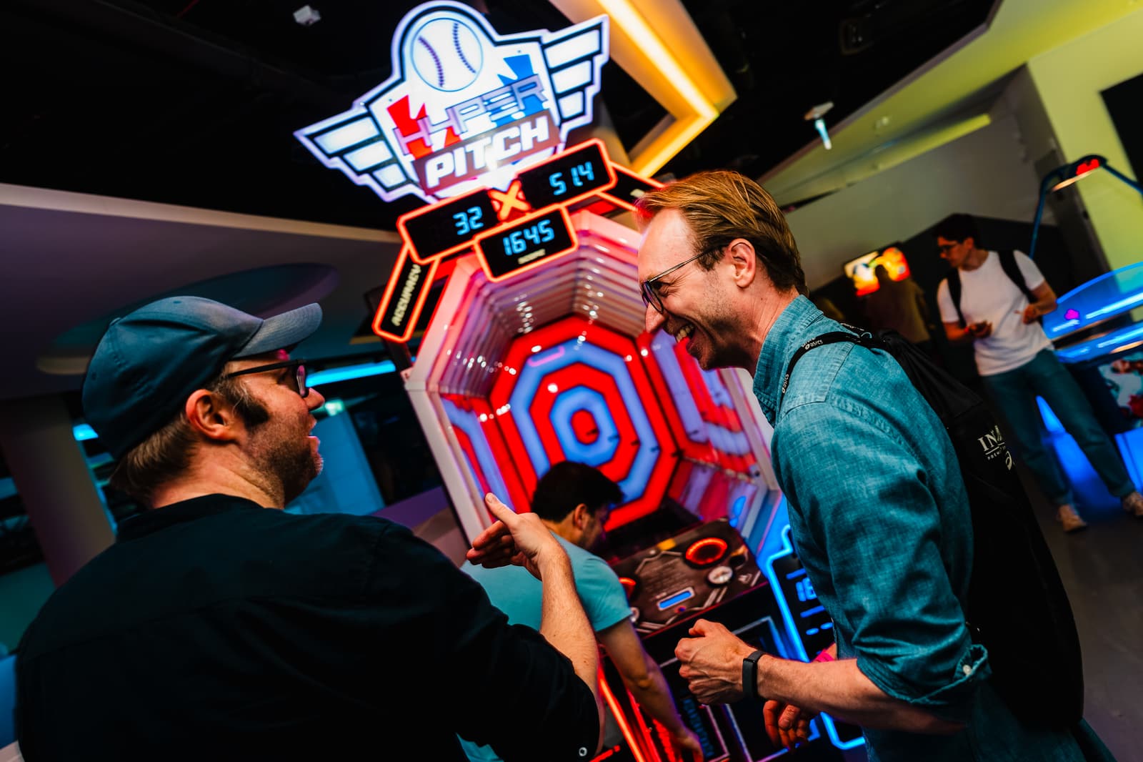 Two guests celebrating a high score together at Hyper Pitch